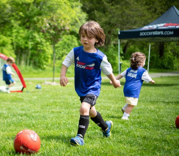 Child dribbling a soccer ball at a Soccer Stars Brooklyn class